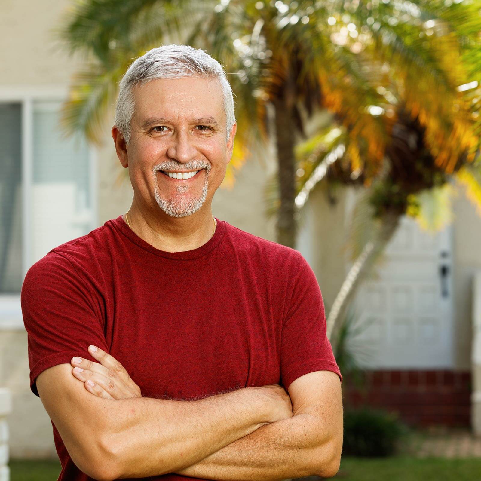 Man Smiling in Front of Palm Trees